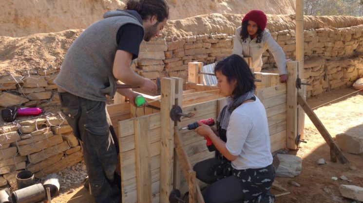 Nitzan Iserovitch von der Back to Earth Community, links, lehrt nepalesische Frauen, eine "Stampferde"-Verschalung zu bauen. Foto Facebook.