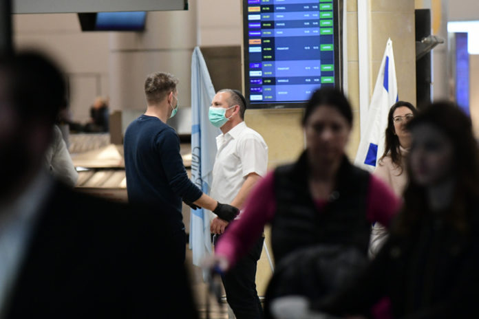 Menschen mit Gesichtsmasken in der Ankunftshalle des Flughafens Ben Gurion bei Tel Aviv am 28. Januar 2020. Foto Tomer Neuberg/Flash90