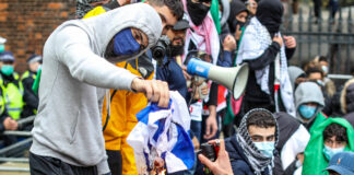 22. Mai 2021: Demonstranten setzen eine israelische Flagge in Brand, als sie sich in der Nähe der israelischen Botschaft in Kensington, im Zentrum Londons versammeln. Unter den teilnehmenden Gruppen waren Sektionen der National Education Gewerkschaft, die Palestine Solidarity Campaign, Palestine Action und Stop The War Coalition. Foto IMAGO / VXPictures.com
