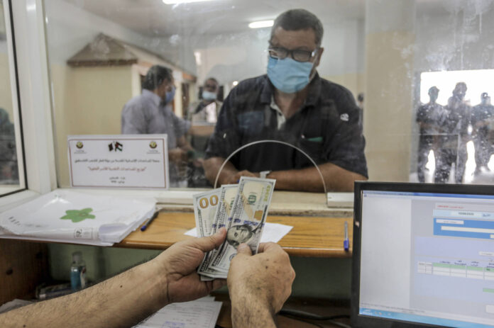 Ein palästinensischer Mann erhält auf dem Postamt in Gaza-Stadt finanzielle Hilfe im Rahmen eines katarischen Hilfsprogramms. Foto IMAGO / ZUMA Wire
