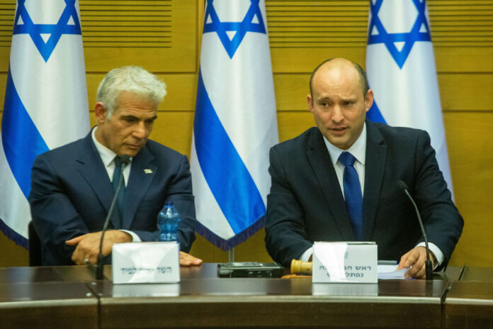 Naftali Bennett, Israels Ministerpräsident und Yair Lapid, stellvertretender Ministerpräsident und Ausenminister, nach der Vereidigung der 36. israelischen Regierung. Jerusalem am 13. Juni 2021. Foto Shalev Shalom/TPS
